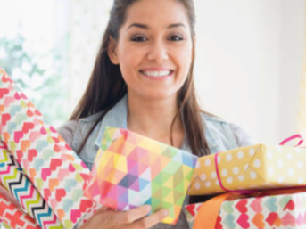 Woman holding gifts wrapped in bright colors